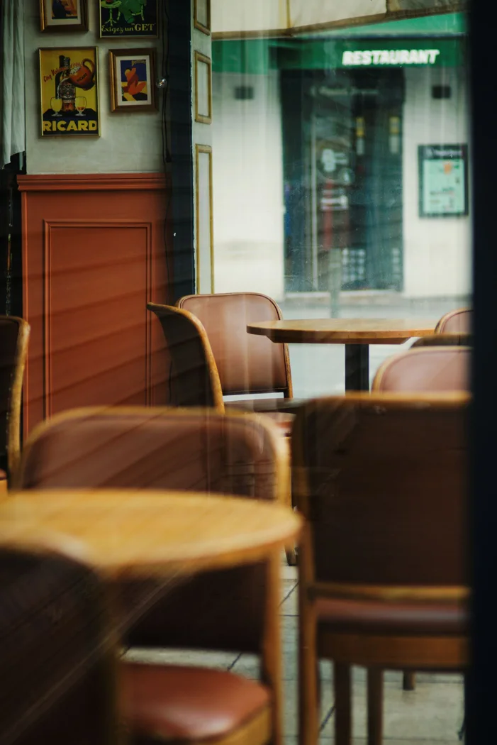 A quiet and inviting cafe with empty chairs and tables, offering a cozy atmosphere.