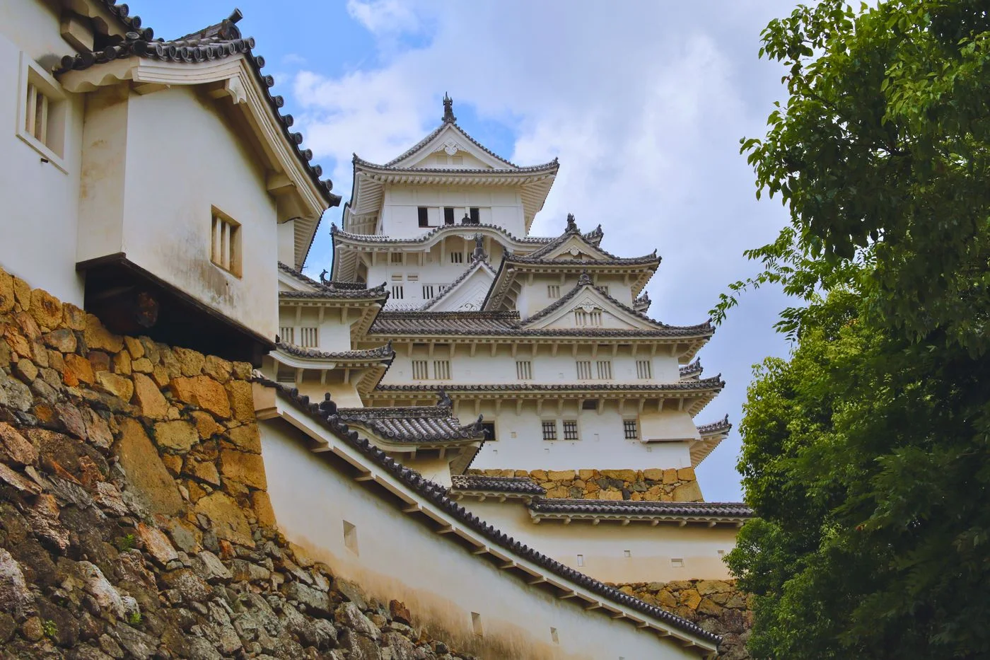 Exterior of Himeji Castle, a UNESCO World Heritage site in Japan, showcasing traditional Japanese architecture.