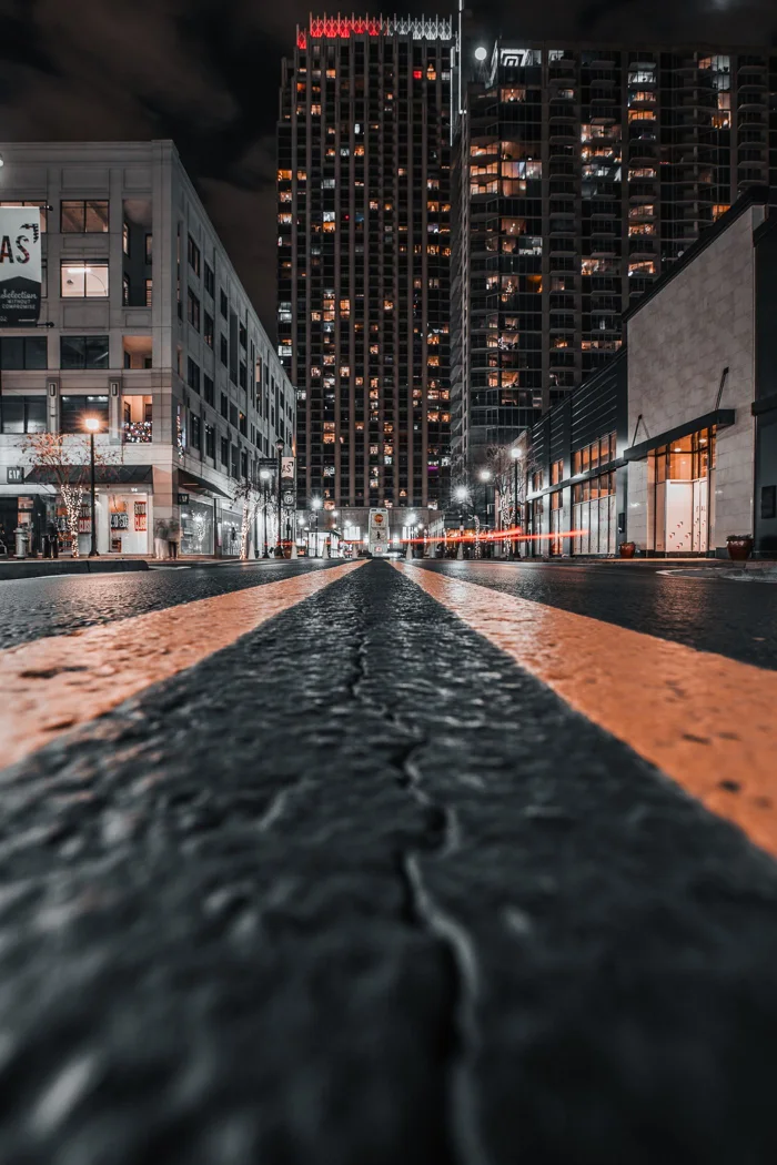 A low-angle night shot of skyscrapers and city street in Atlanta, GA.