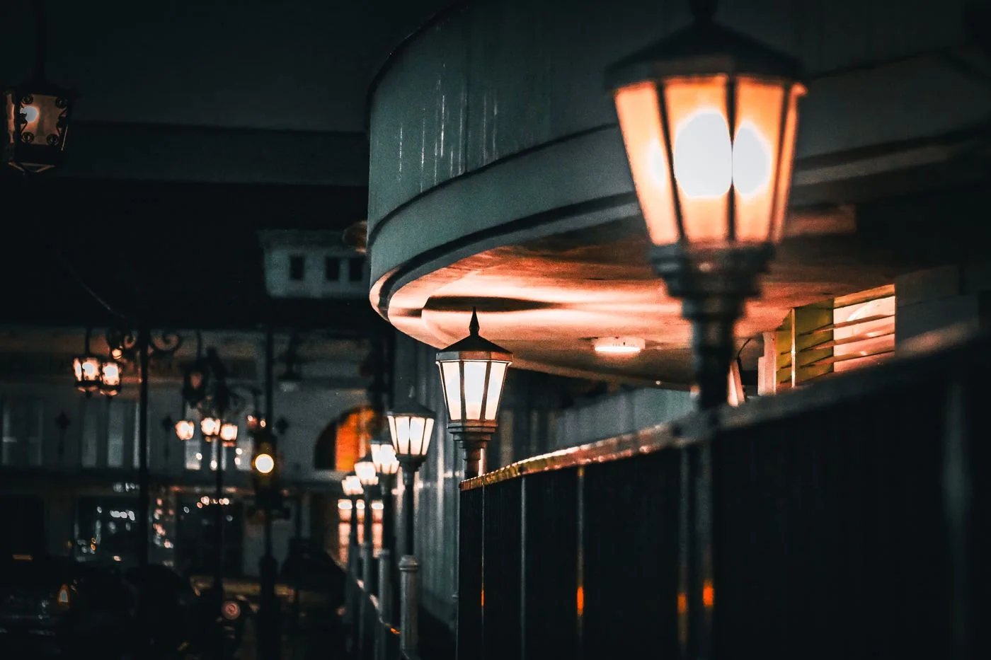 Atmospheric night scene with vintage street lamps casting warm glow in urban setting.