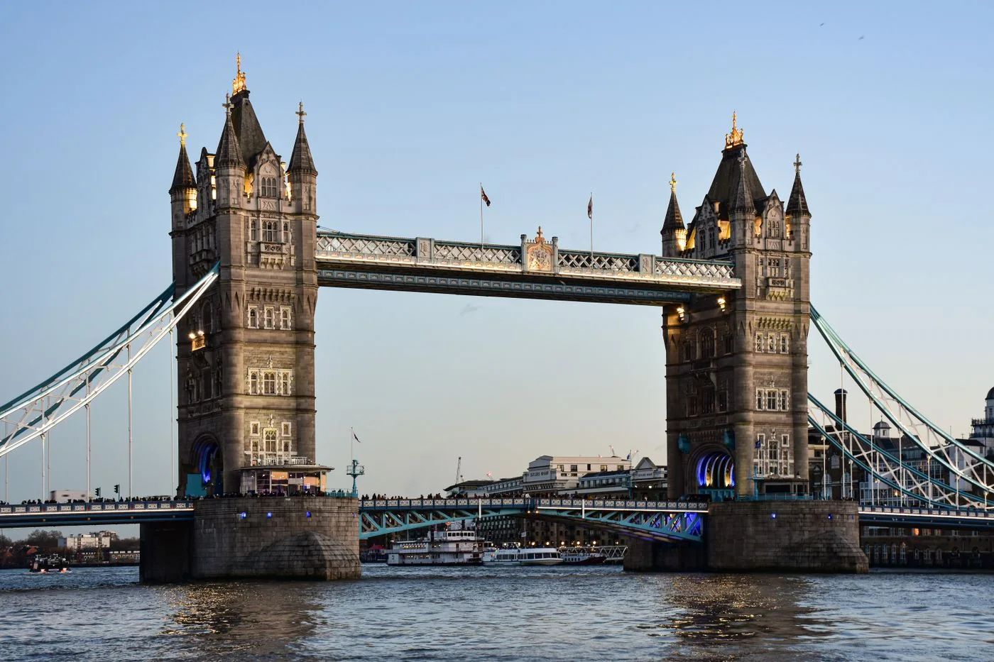 Iconic Tower Bridge in London spans the River Thames at dusk, showcasing historic architecture.
