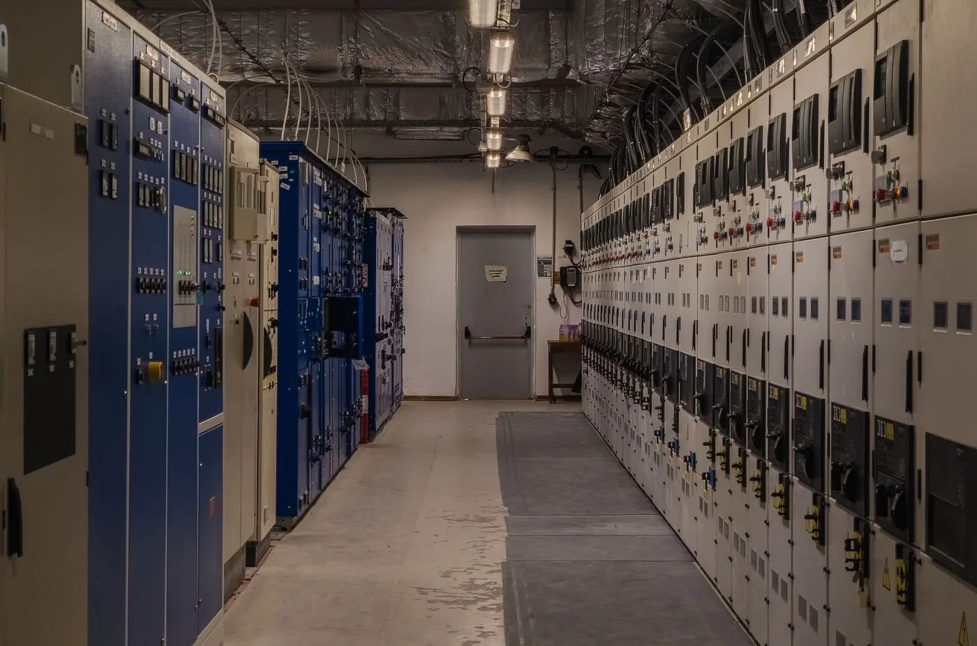 A sophisticated control room filled with electrical panels and equipment for industrial purposes.