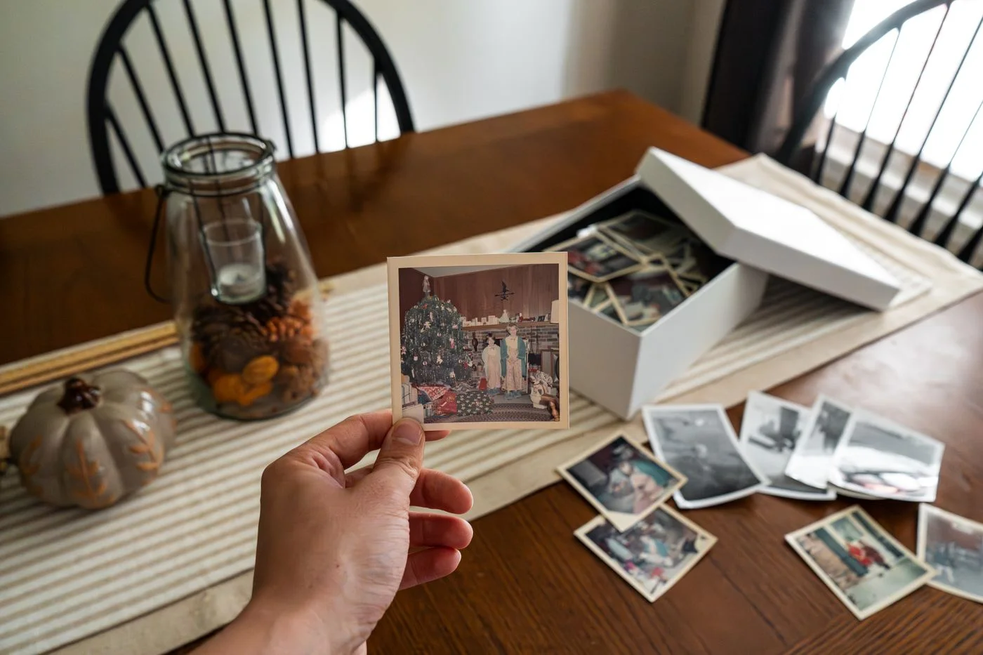 A nostalgic collection of vintage family photos displayed on a wooden table.