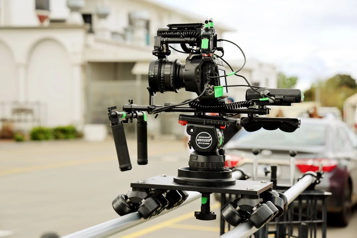 High-end camera rig mounted on a dolly track for film production outdoors.