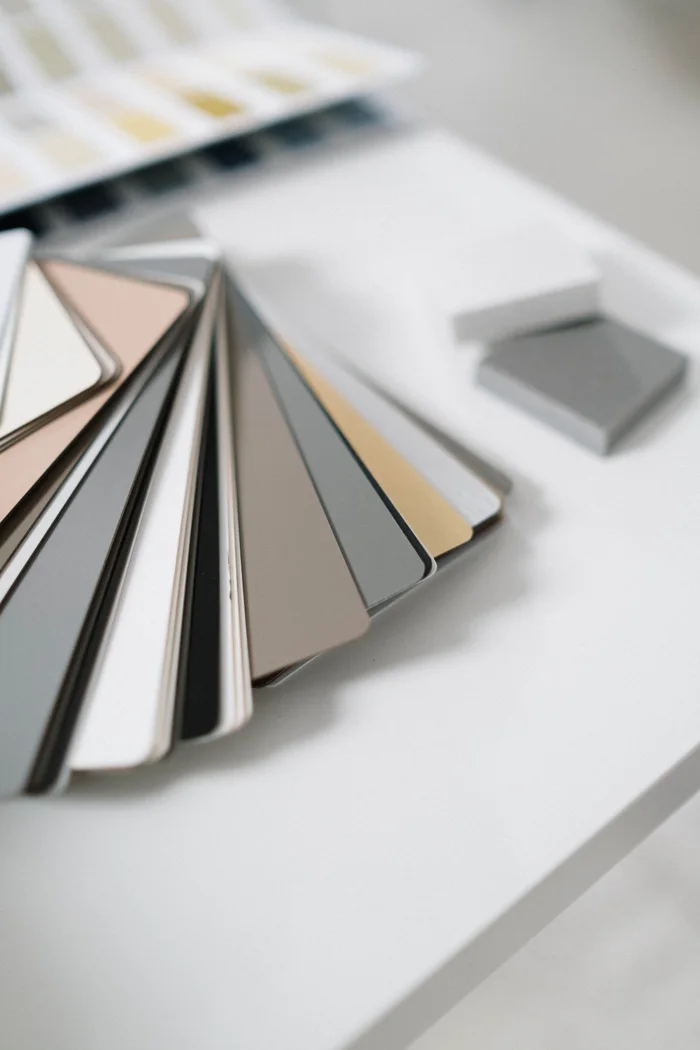 A collection of sleek color swatches on a white table for sophisticated interior design planning.