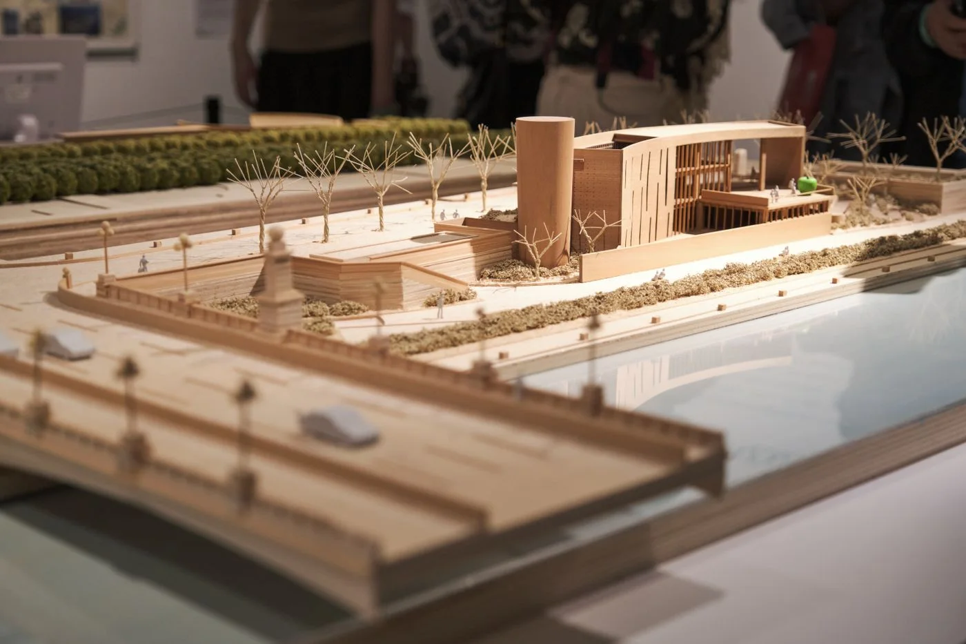 Detailed wooden architectural scale model displayed in an exhibition environment.